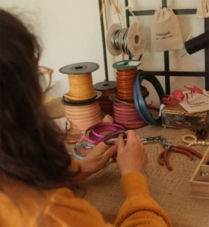 craftswoman making a leather bracelet