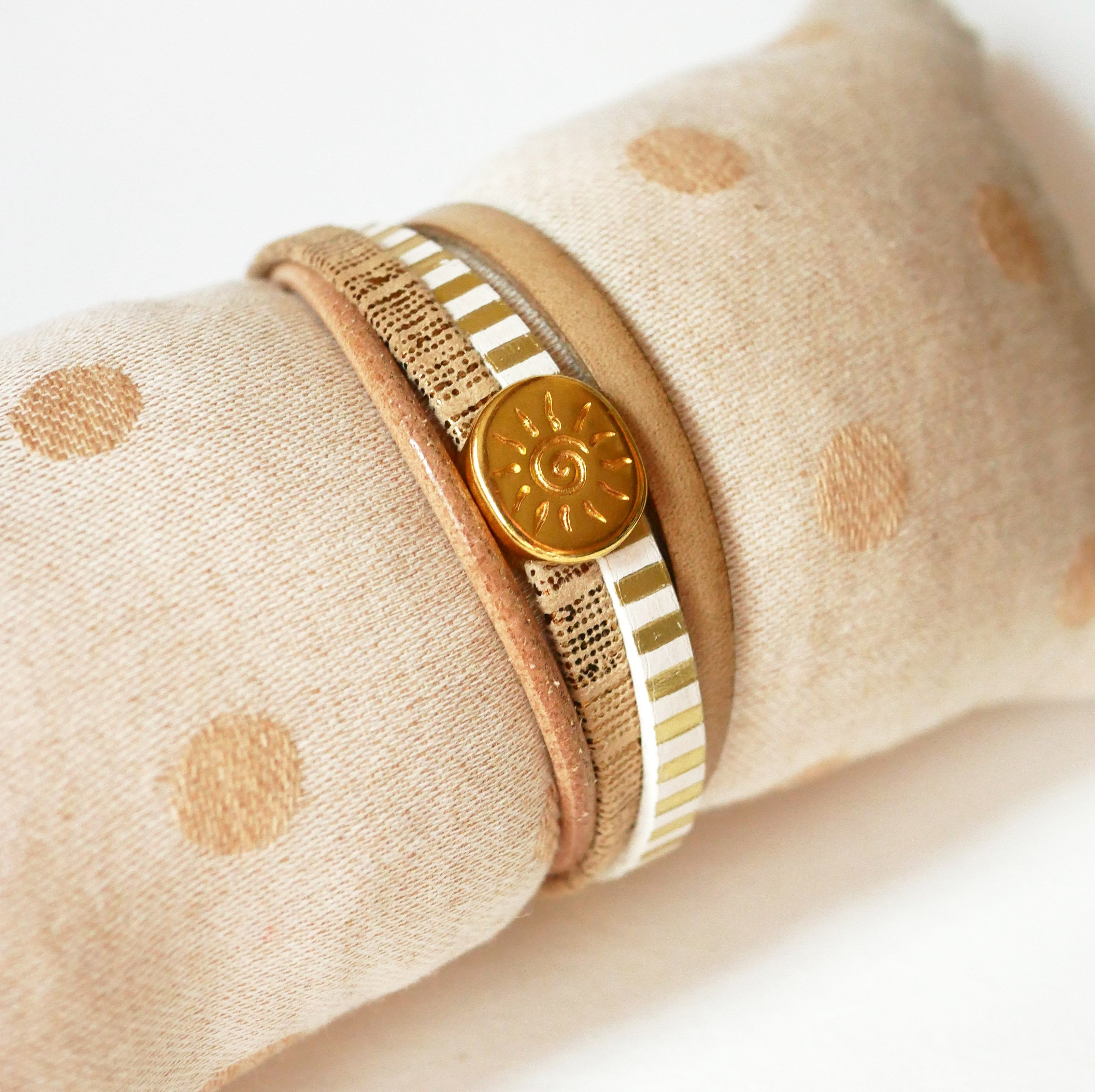Multi-link leather cuff bracelet with gold sunburst loop