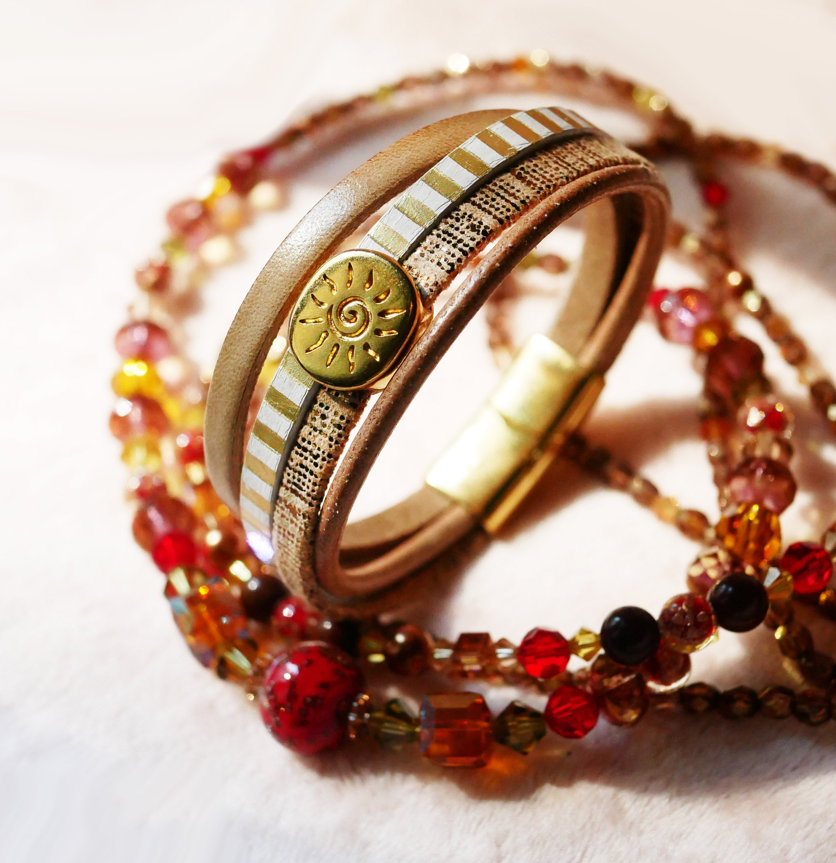 Multi-link leather cuff bracelet with gold sunburst loop