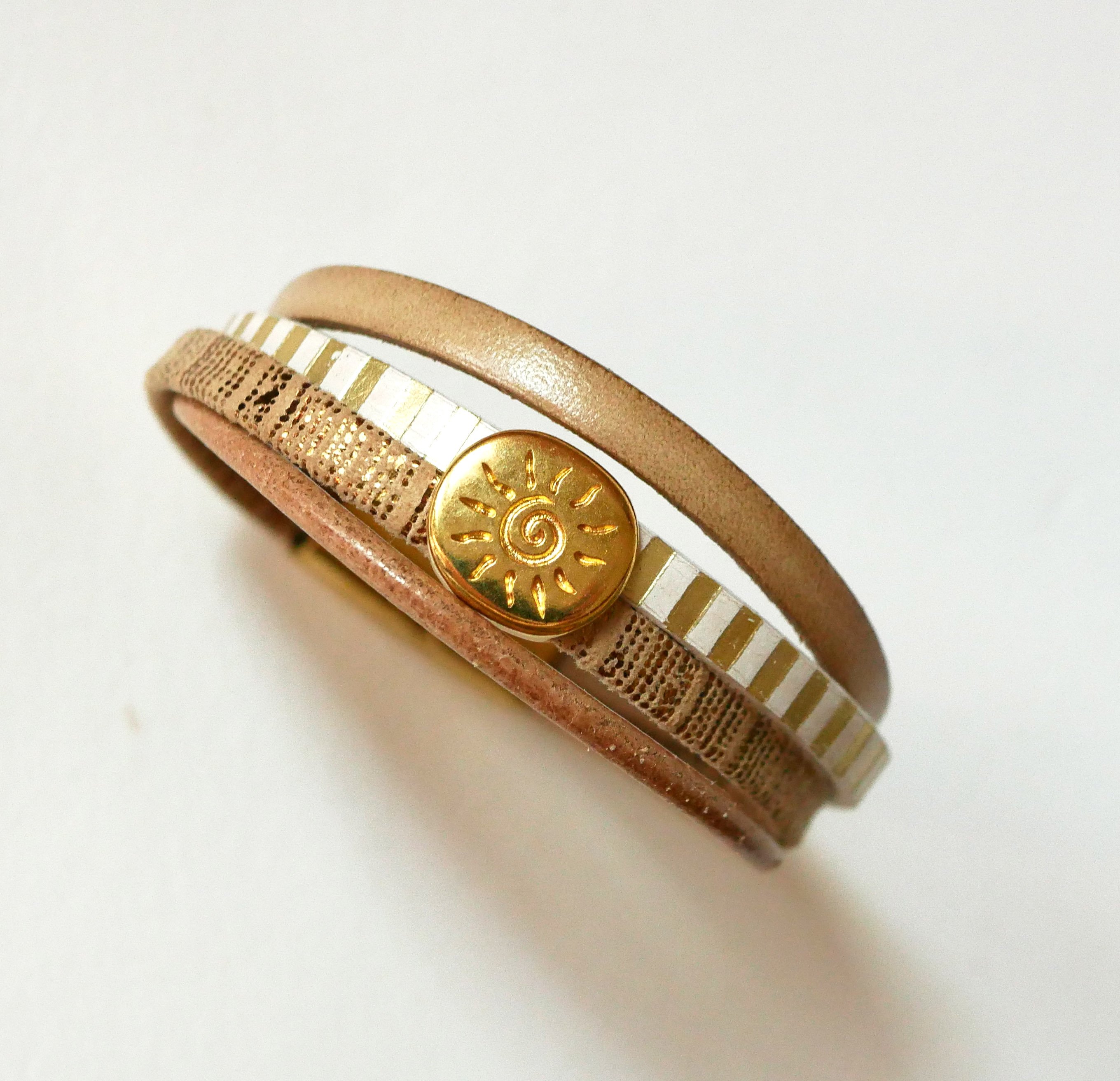 Multi-link leather cuff bracelet with gold sunburst loop