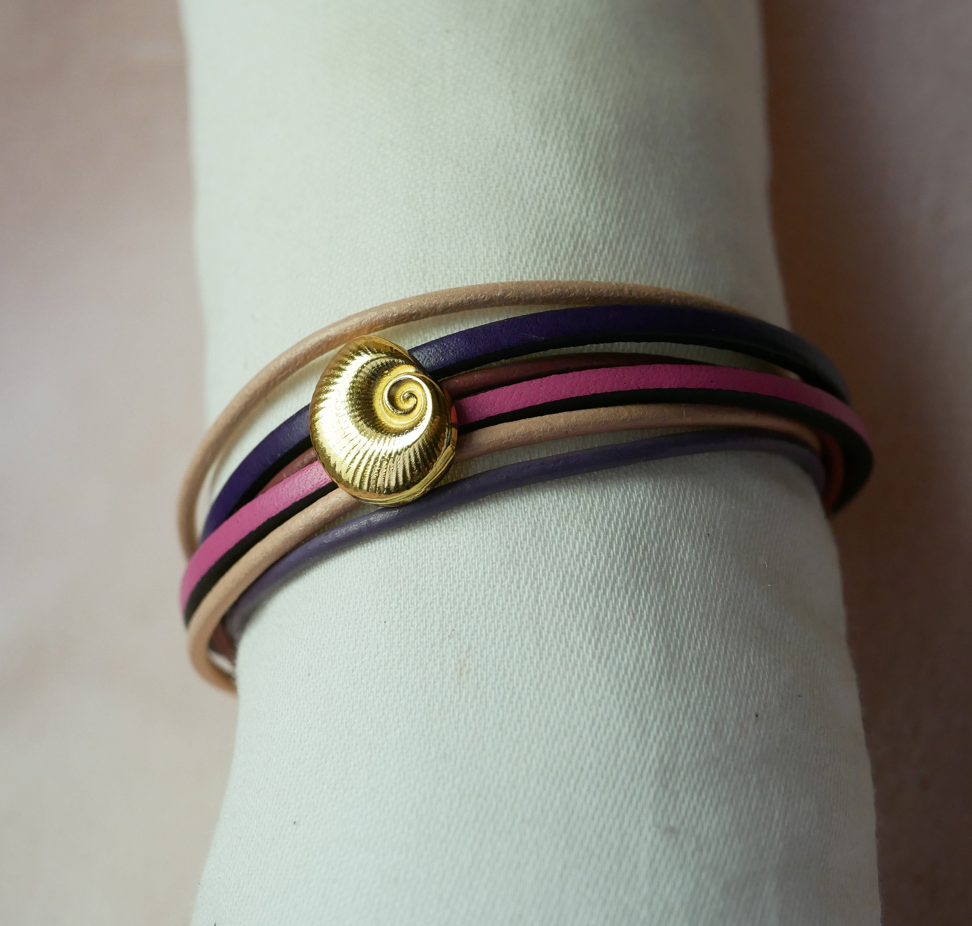 Multi-link bracelet in peach and mauve leathers with gold shell decoration