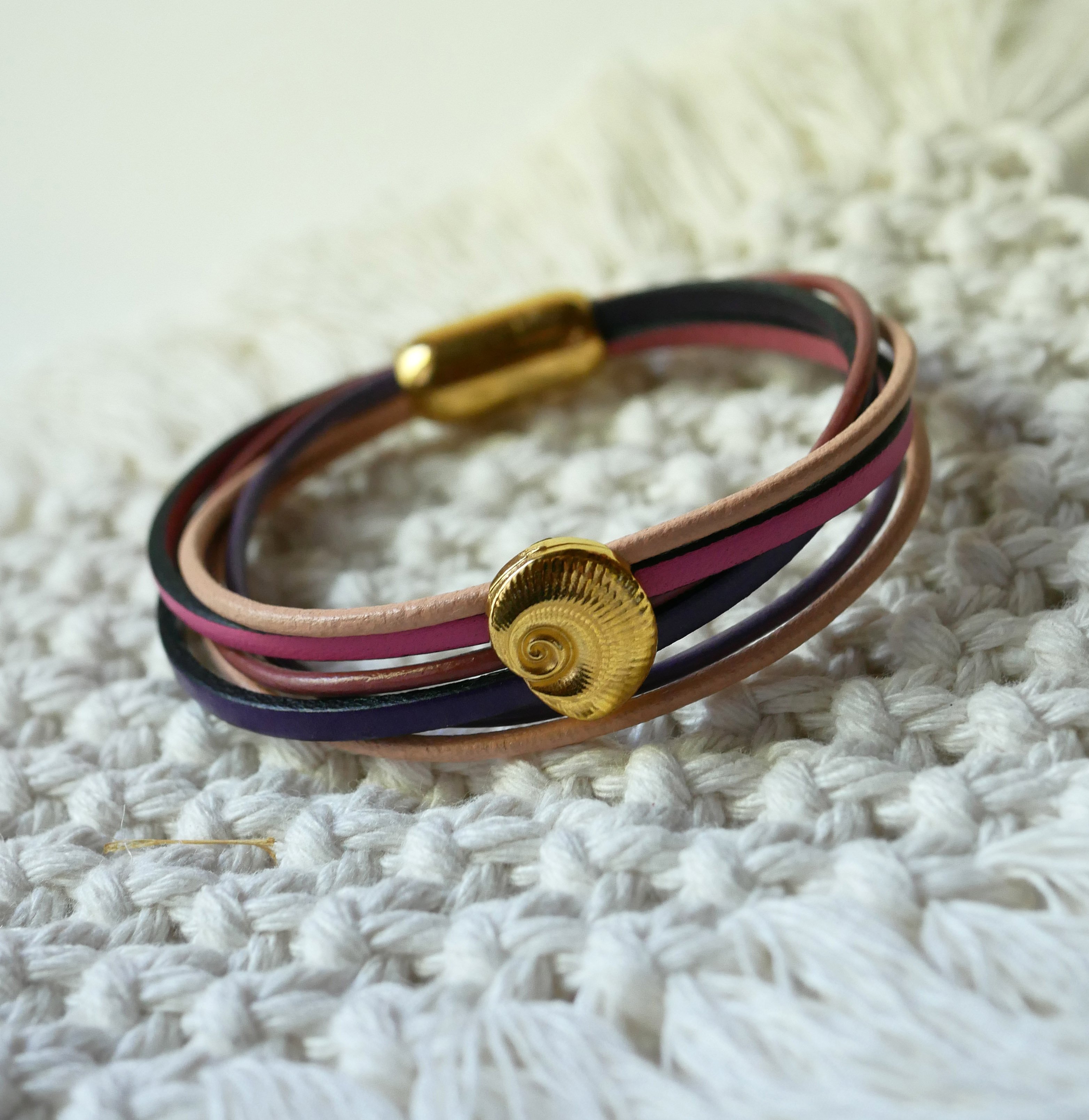 Multi-link bracelet in peach and mauve leathers with gold shell decoration
