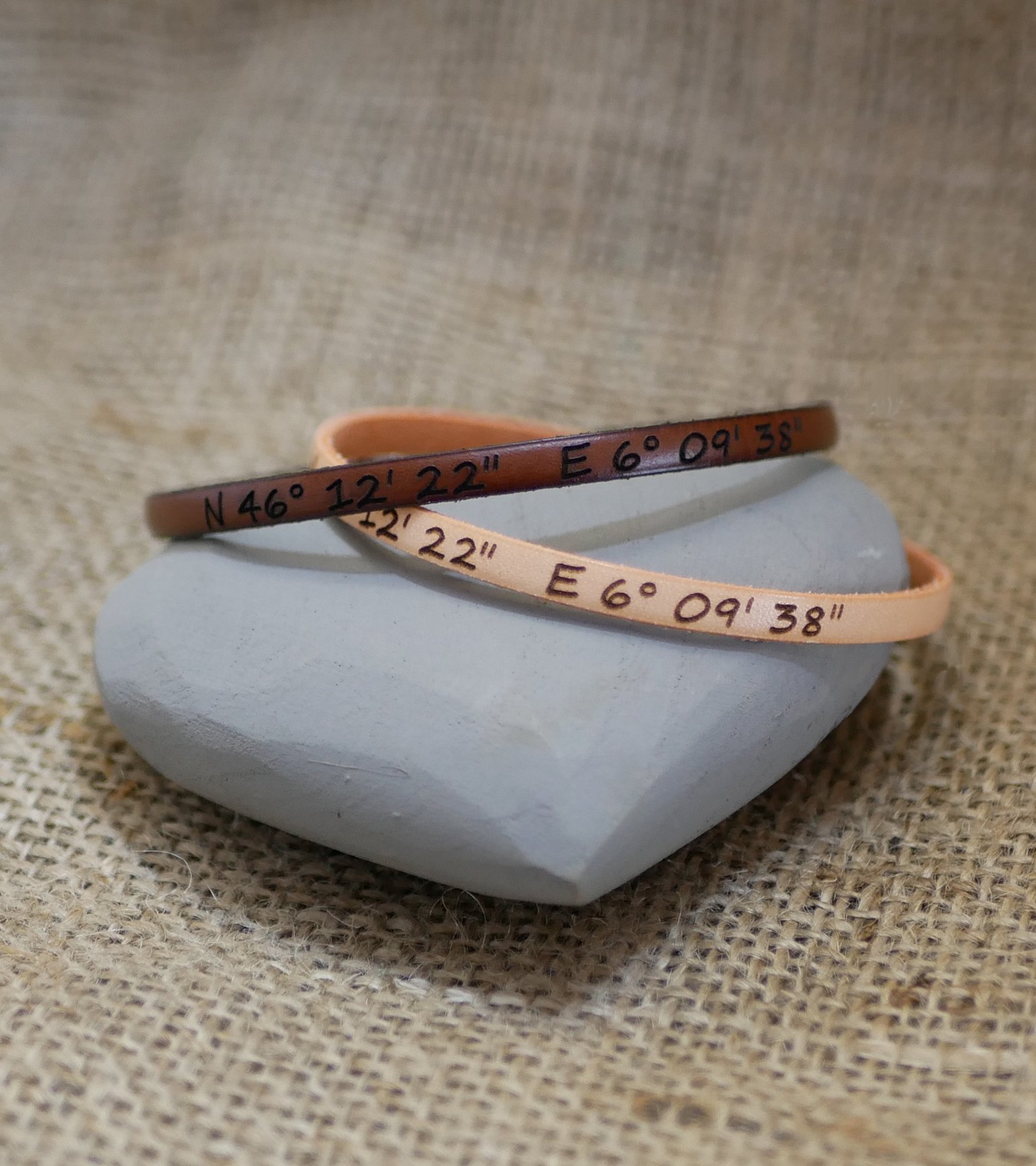 Gift bracelets for couples in leather, both personalized with the same engraving 