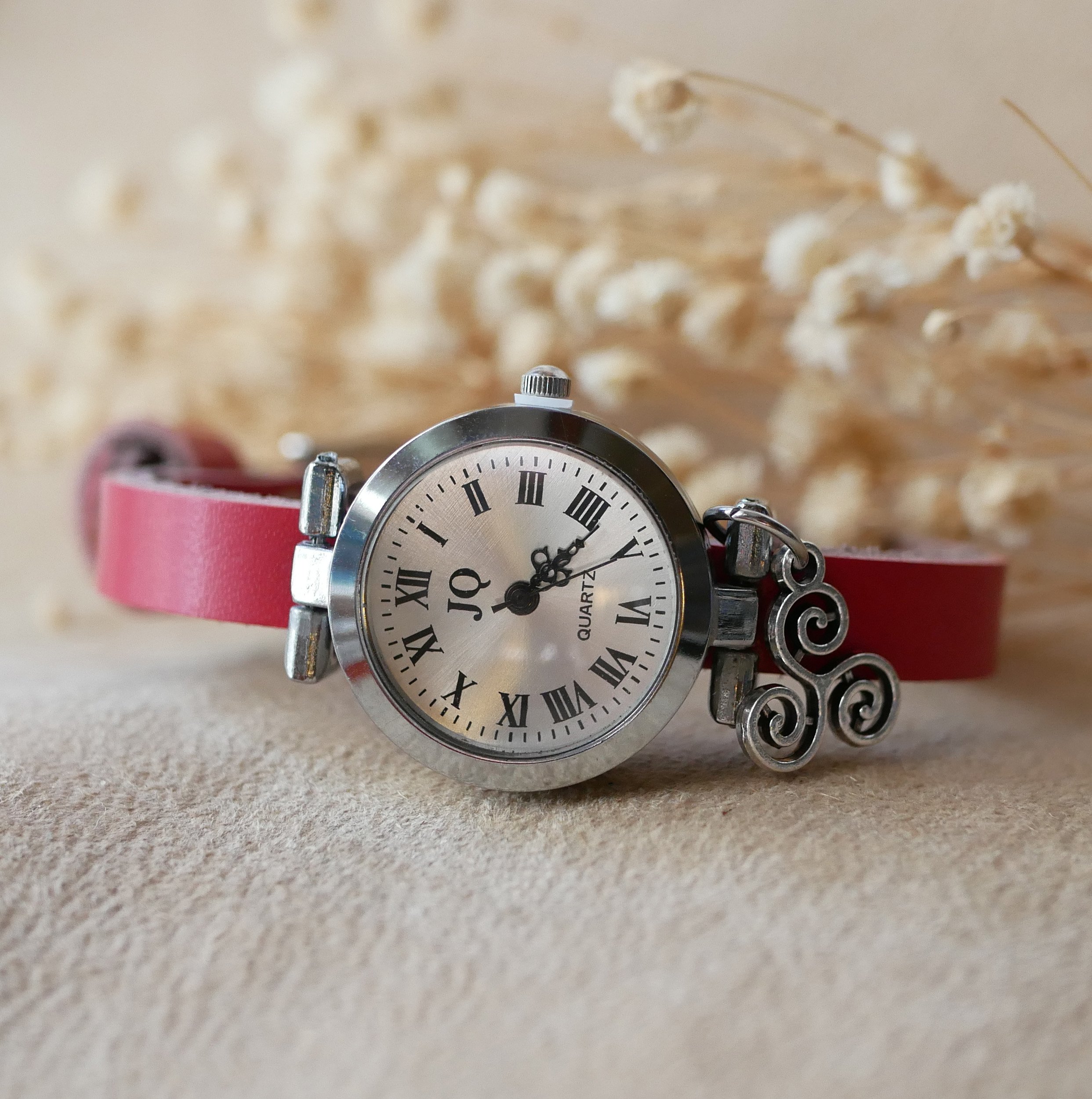 Silver watch with leather strap and silver buckle