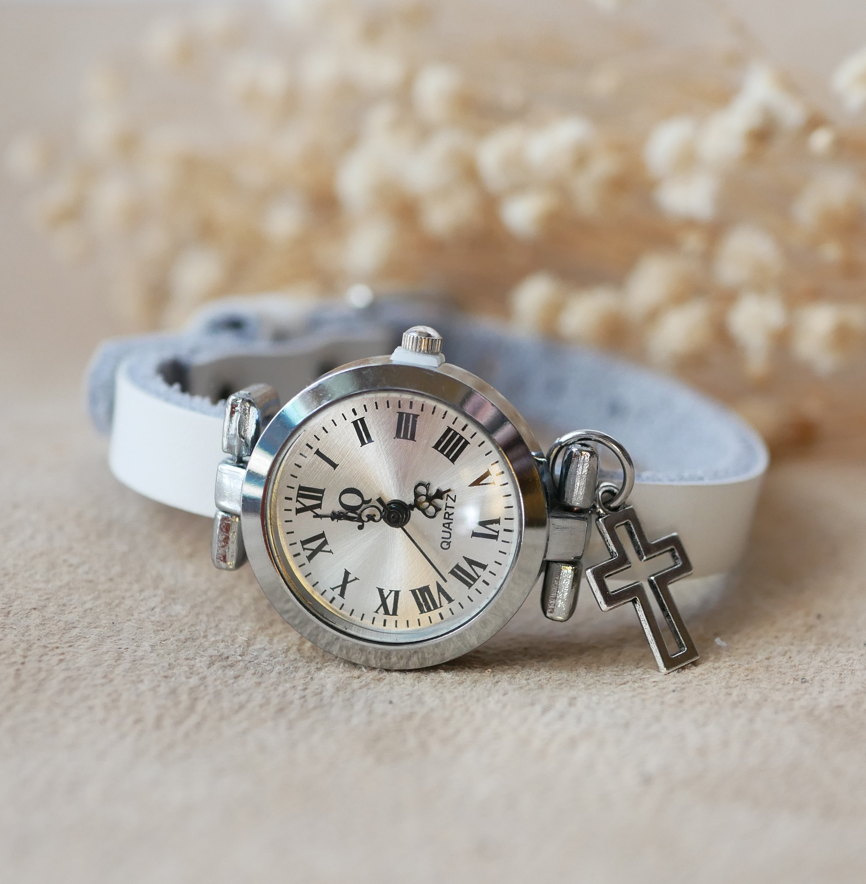 Silver watch with leather strap and silver buckle