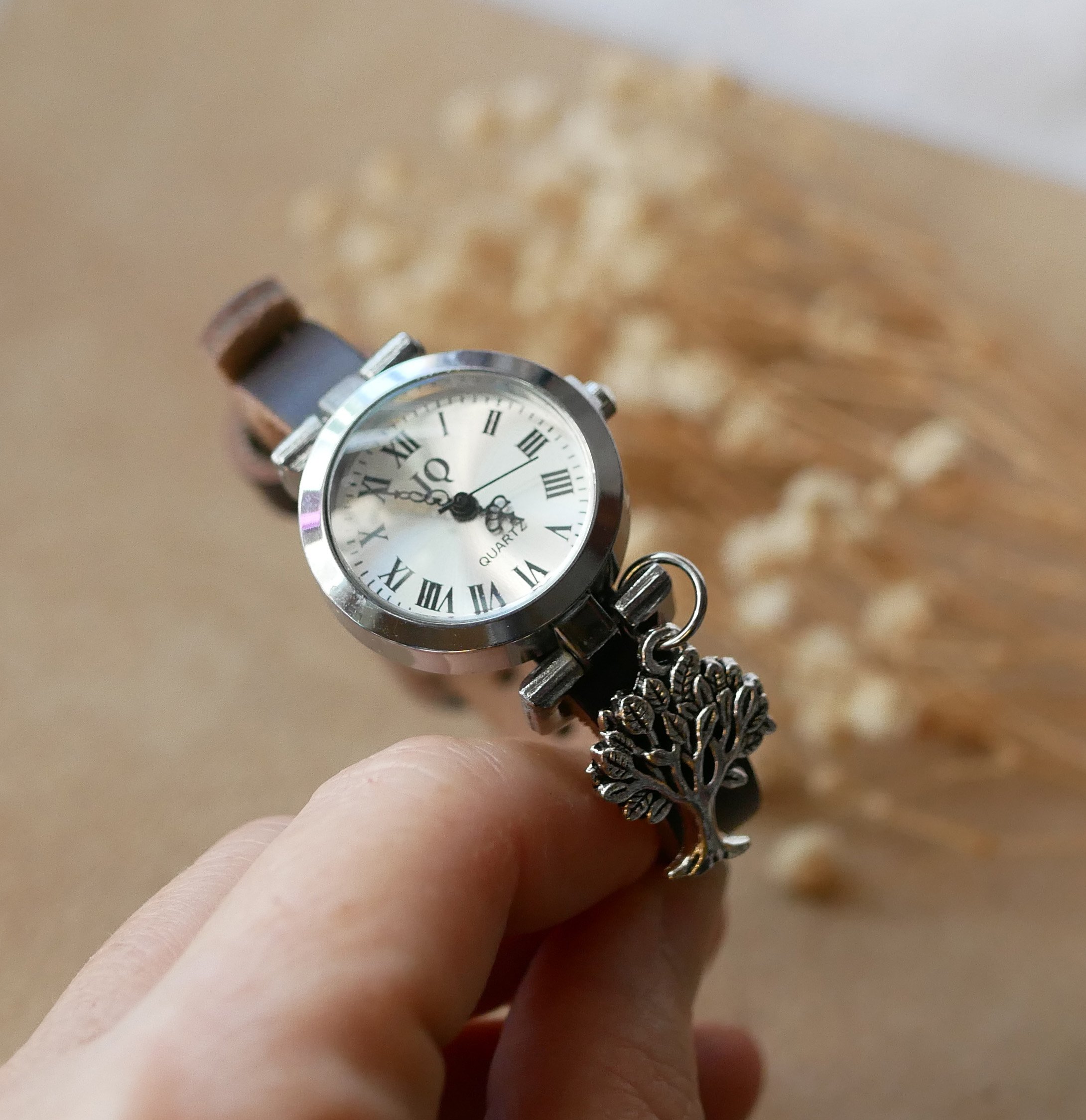 Silver watch with leather strap and silver buckle