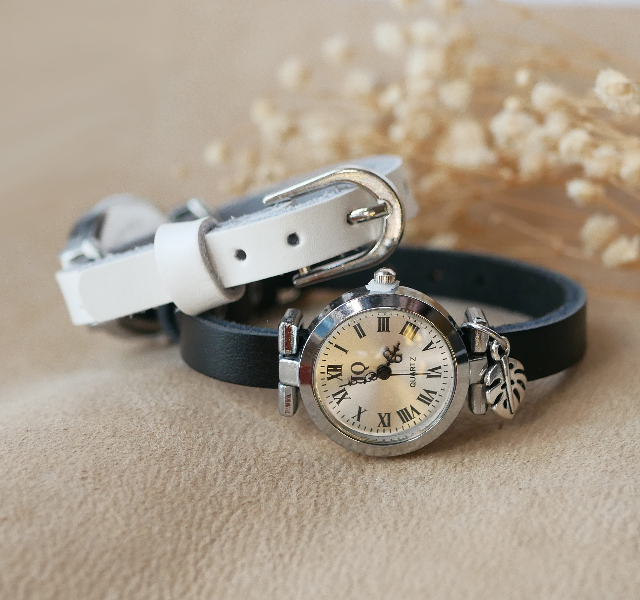 Silver watch with leather strap and silver buckle