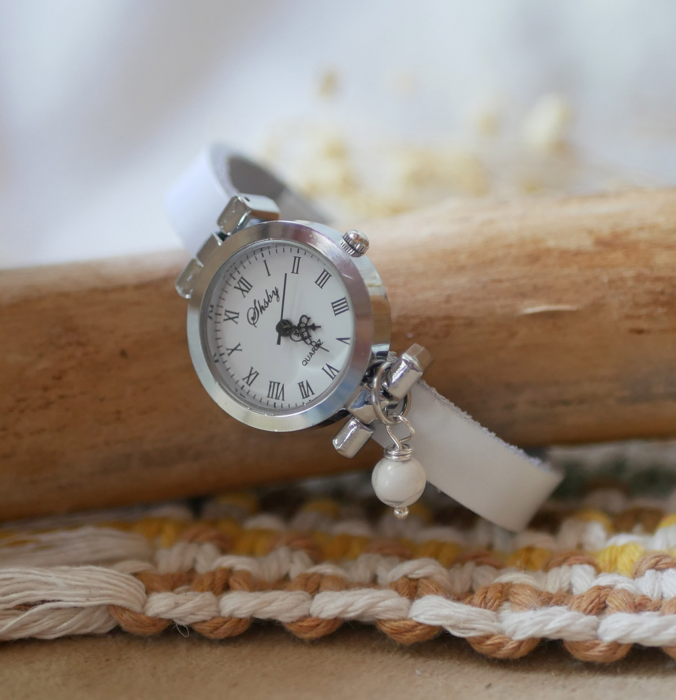 Silver watch with charm and leather strap with adjustable clasp