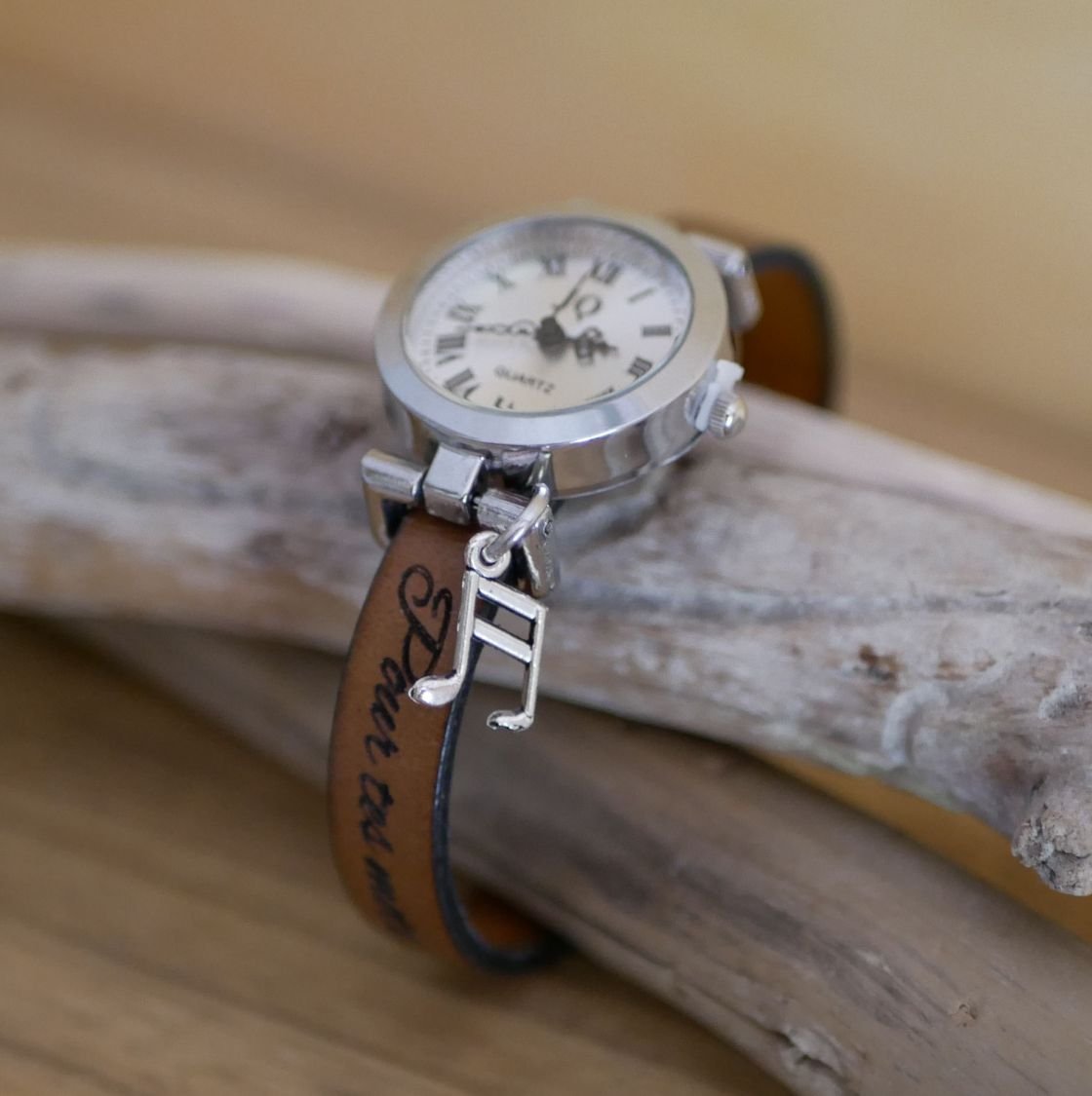 Silver watch with charm and leather strap with adjustable clasp