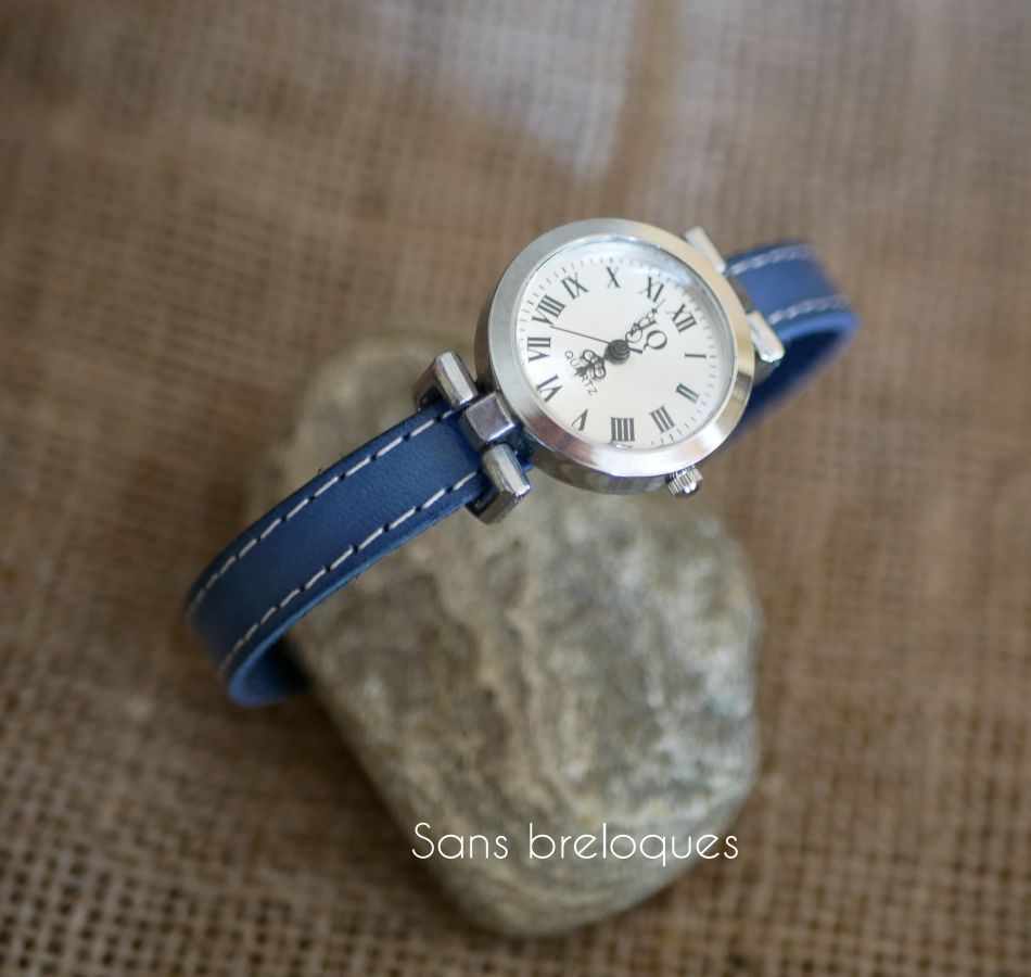 Watch with blue leather strap and white stitching