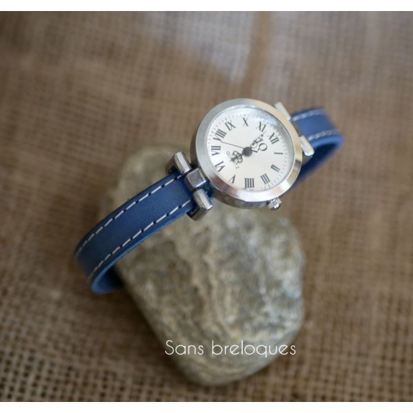 Watch with blue leather strap and white stitching