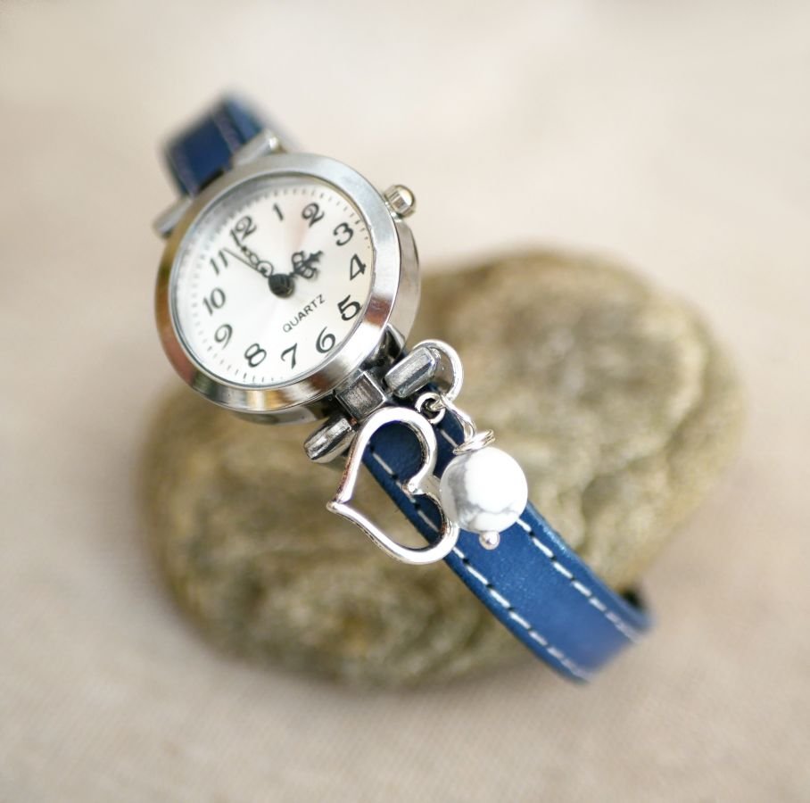 Watch with blue leather strap and white stitching