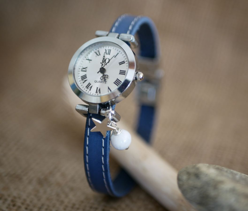 Watch with blue leather strap and white stitching