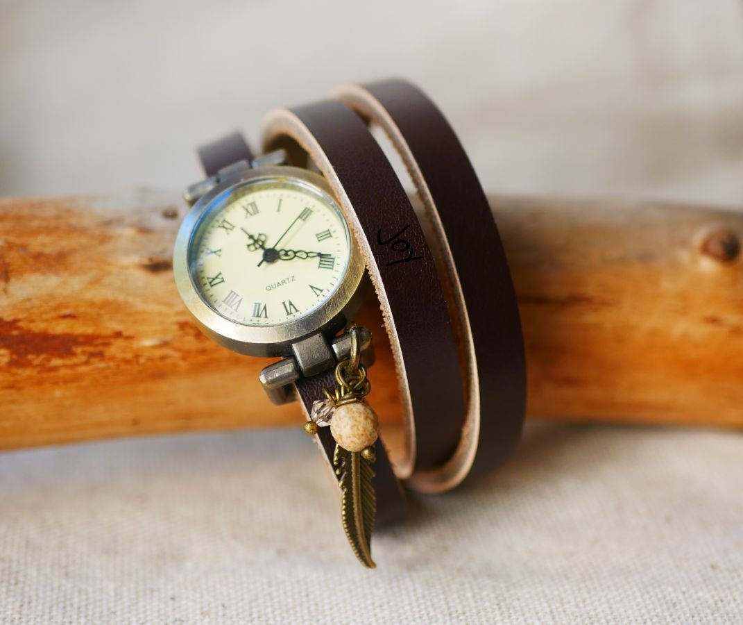 Leather bracelet watch with feather and pearl charms