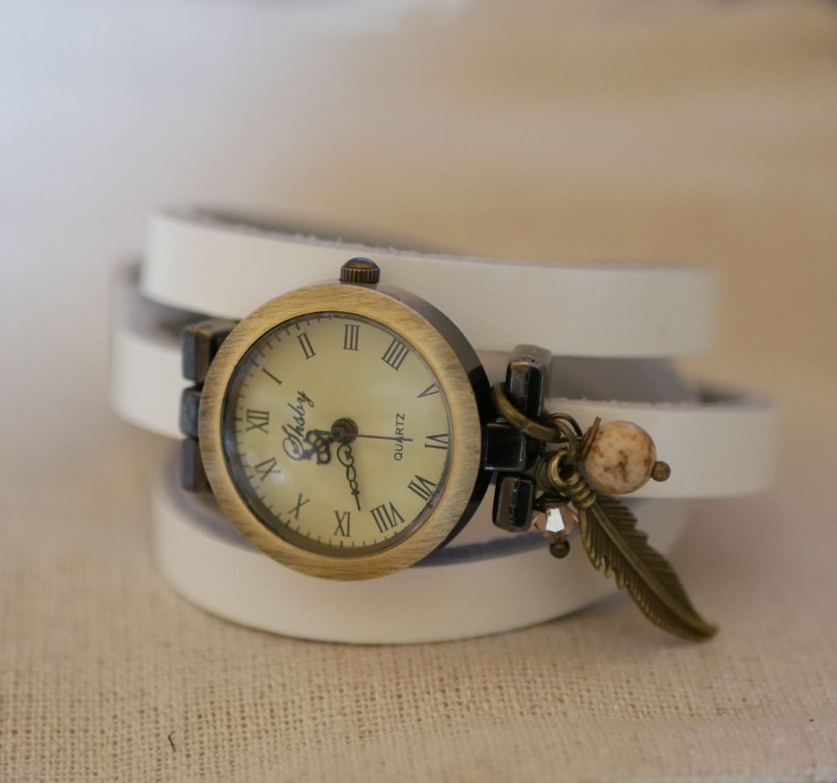 Leather bracelet watch with feather and pearl charms