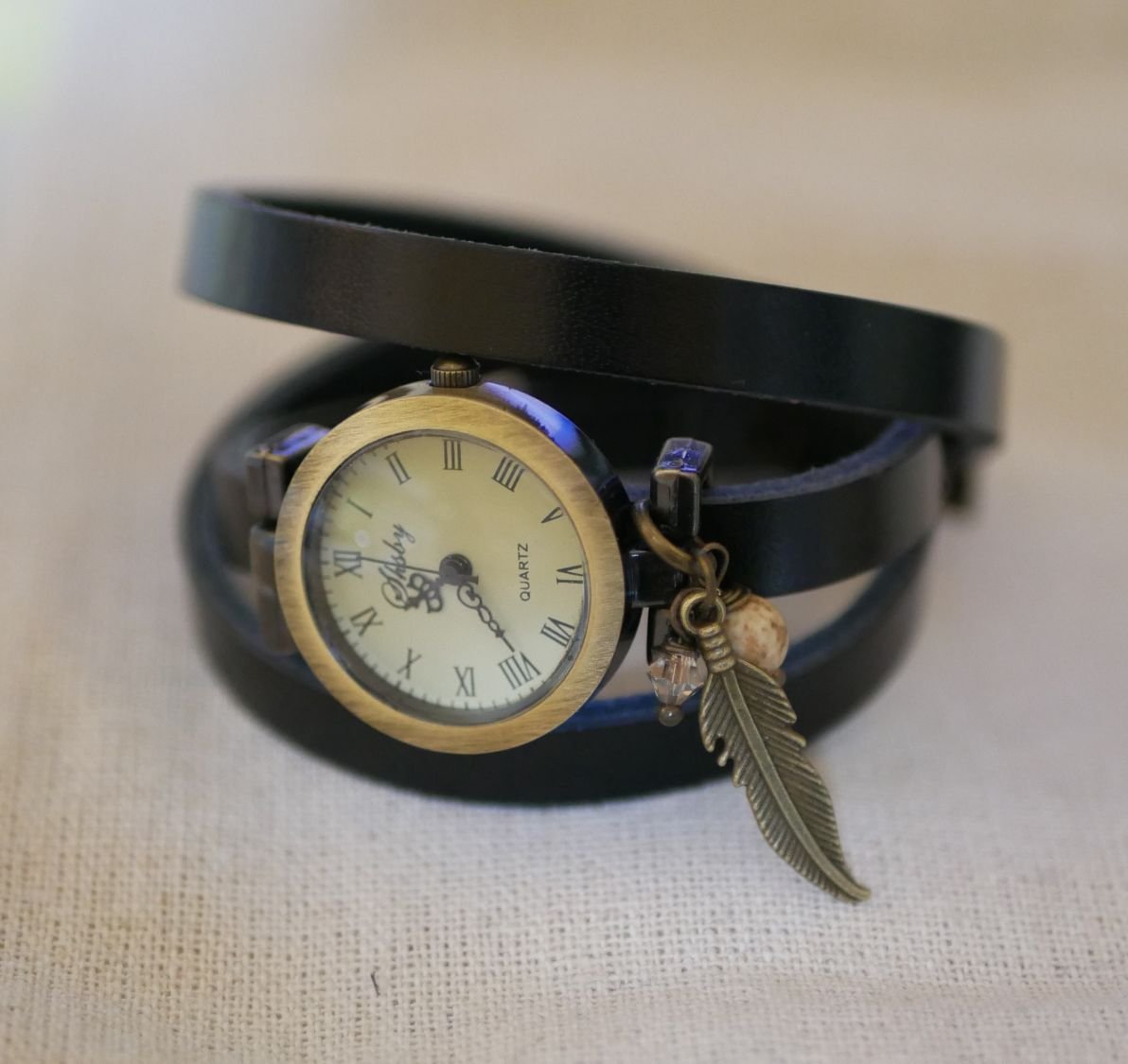 Leather bracelet watch with feather and pearl charms