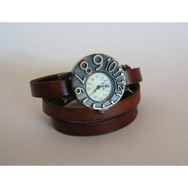 Watch with leather strap and asymmetrical dial