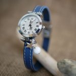 Watch with blue leather strap and white stitching